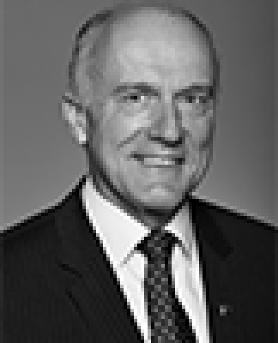 Black and white head shot of Eric Abetz, former Special Minister of State. He is wearing a dark suit jacket, white shirt and a tie. 