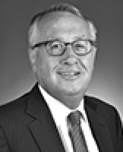 Black and white head shot of Wayne Swan, former Minister for Finance and Deregulation. He is smiling and wearing a dark jacket, white shirt and tie.