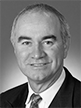 Black and white head shot of Gary Nairn, former Special Minister of State. He is smiling and wearing a dark jacket, white shirt and striped tie. 