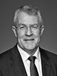 Black and white head shot of Mark Dreyfus, former Special Minister of State. He is smiling, wearing a dark suit jacket, white shirt and tie. 