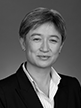 Black and white head shot of Penny Wong, former Minister for Finance and Deregulation. She is smiling and wearing a dark jacket and shirt. 